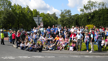 loads of people sat by the side of the road